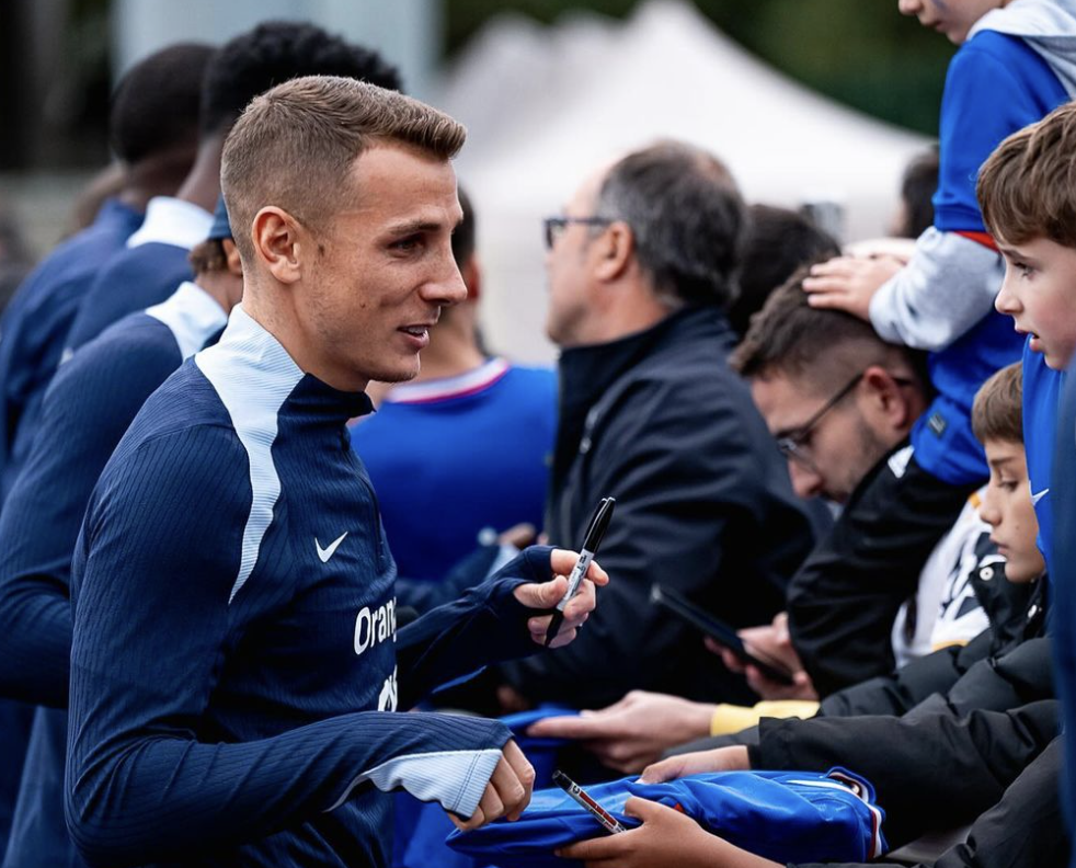 Lucas Digne signe des autographes avec l’équipe de France de football