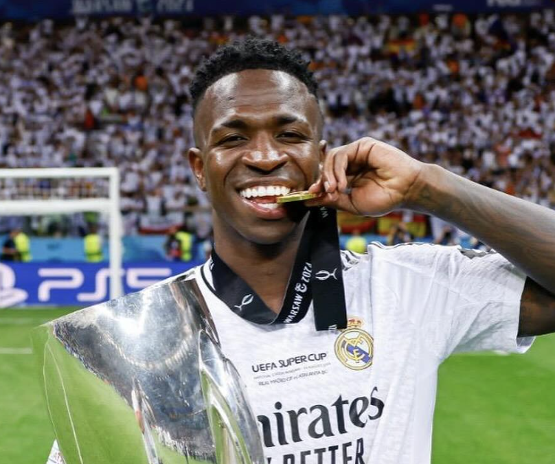 Vinícius José Paixão de Oliveira Júnior qui mordille sa médaille de la Ligue des Champions au Real Madrid