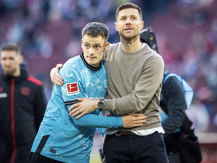 Florian Wirtz et Xabi Alonso qui s’enlacent après une victoire du Bayer Leverkusen